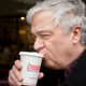man sipping on hot dunkin coffee